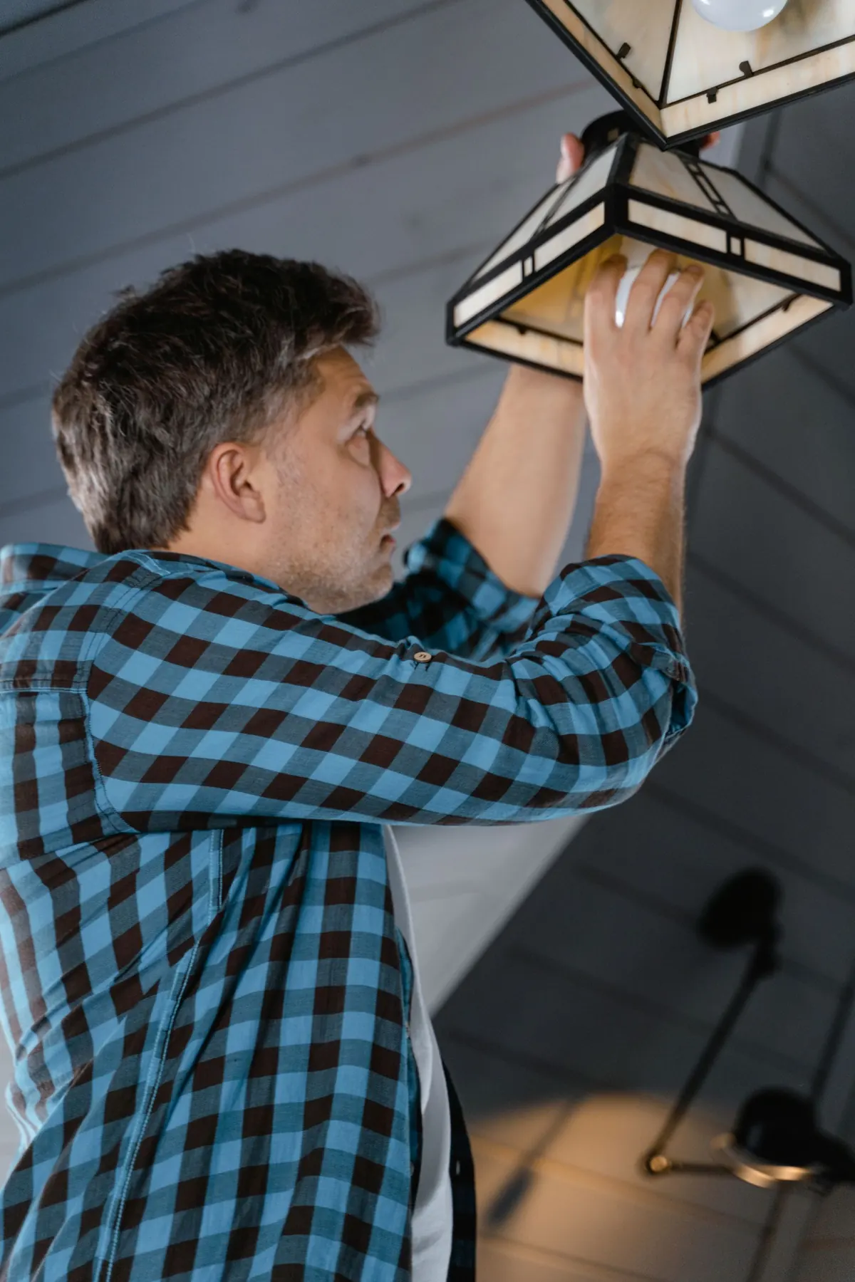 Electrician installing a light fixture